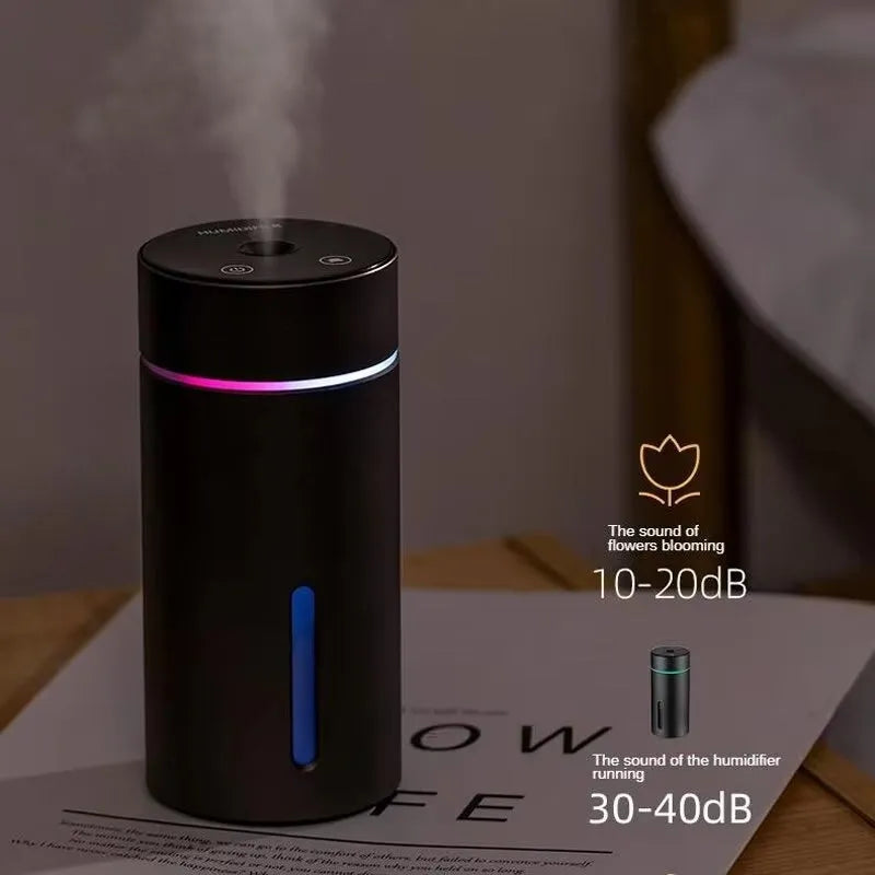 Black portable car humidifier and essential oil diffuser with aluminium body and colourful night light on