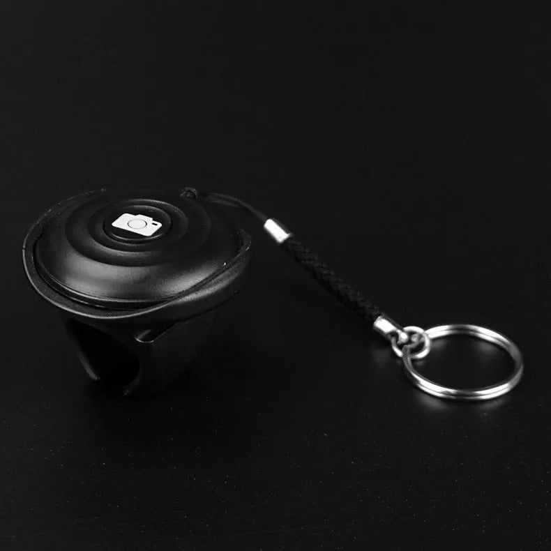 Black Bluetooth remote control shutter for wireless smartphone camera photos and videos.
