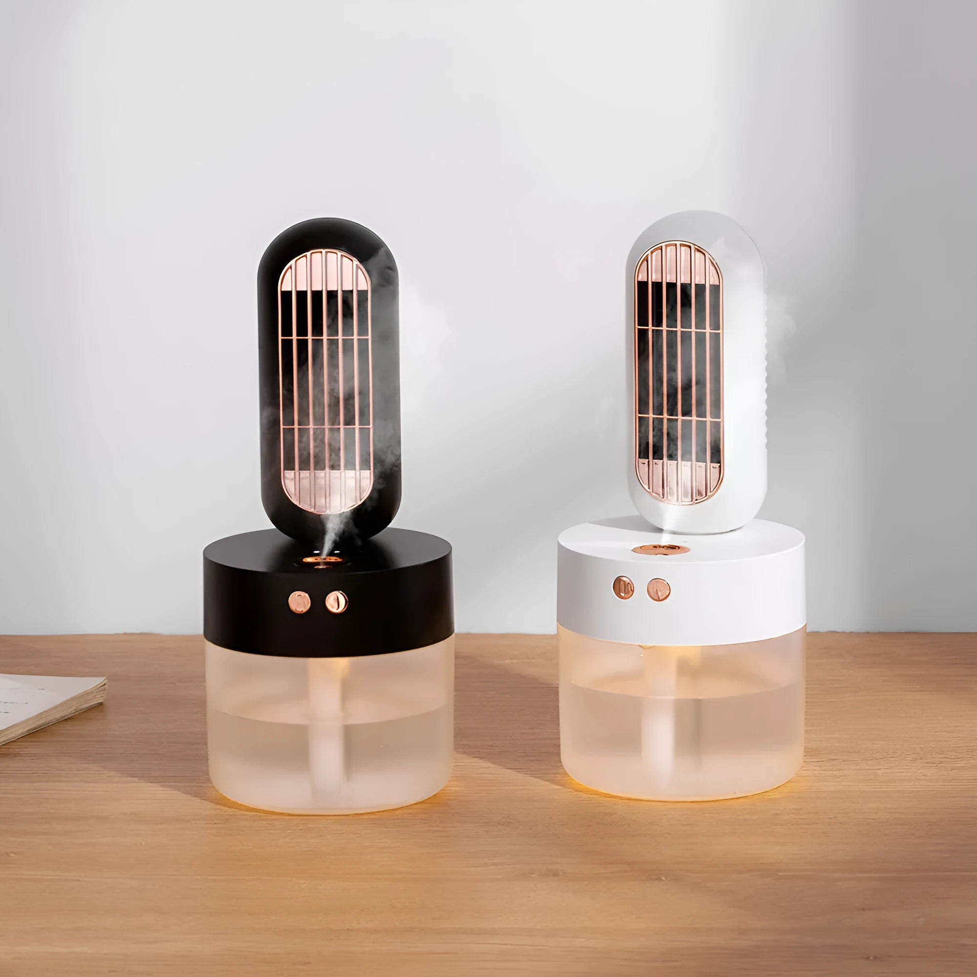 Small black and white humidifier fan with oscillating head on a table