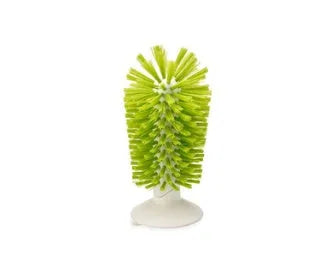 Grey kitchen cleaning brush with two brush heads and suction cups for wall mounting