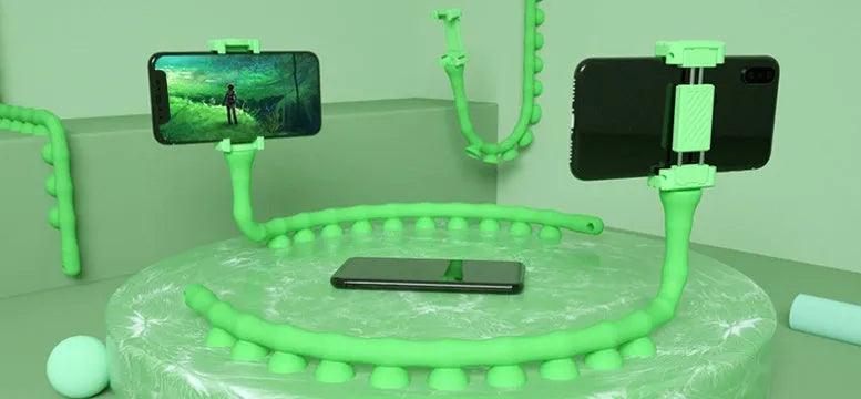 Flexible worm-style lazy bracket mobile phone holder with long silicone arm and black rubber suction cup base.