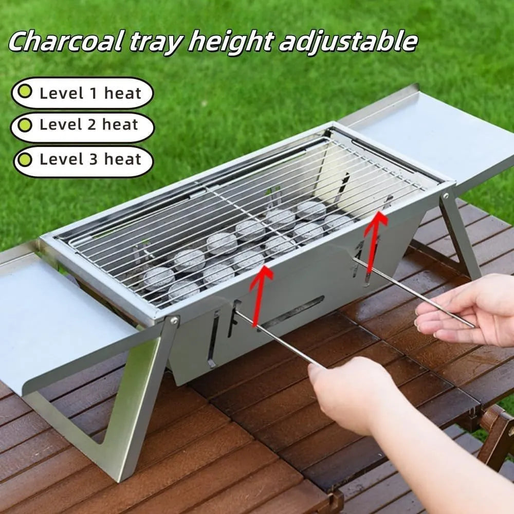 A small, foldable portable charcoal grill for outdoor cooking.