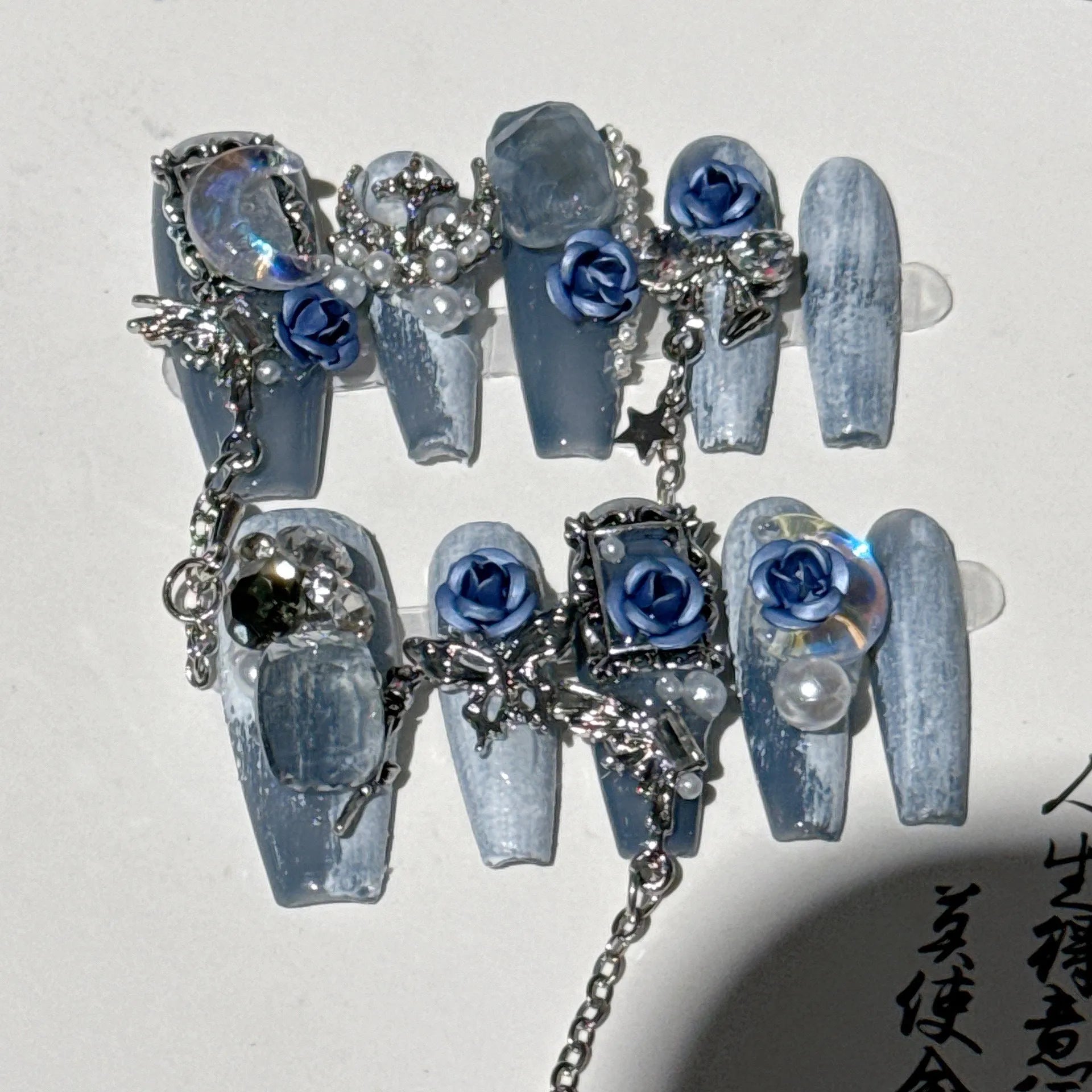 Blue plastic nail armour suit with rose and tulip patterns for evening wear.