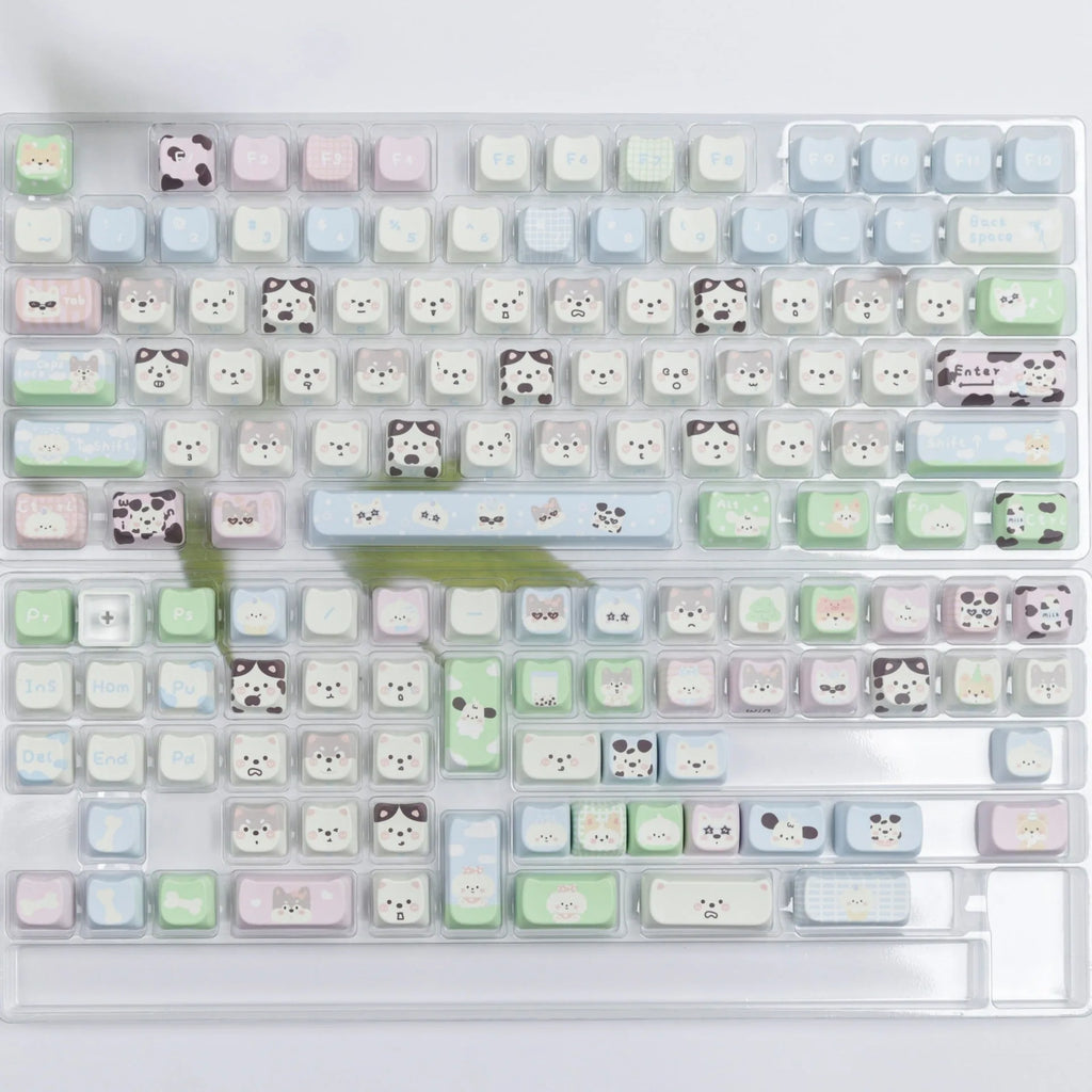 Full set of colourful PBT keyboard keycaps with sublimated cute puppy and cat designs laid out.