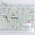 Full set of colourful PBT keyboard keycaps with sublimated cute puppy and cat designs laid out.