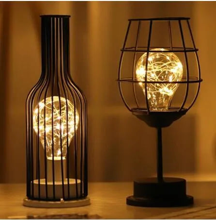 Minimalist hollow wrought iron table lamp with warm white LED light in decorative bottle style
