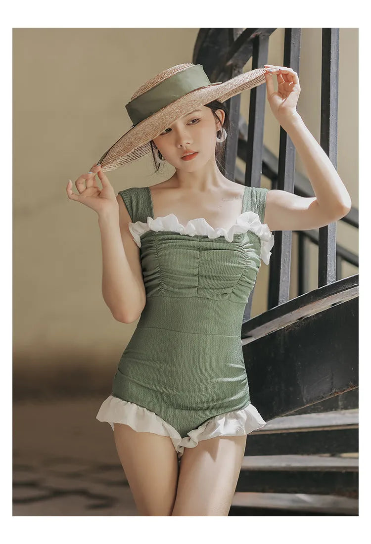 Women's black high-waisted one-piece triangle swimsuit, Korean style, on a mannequin.