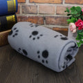 Pet warm blanket with paw print design double-sided fleece in blue colour, laid flat on a surface