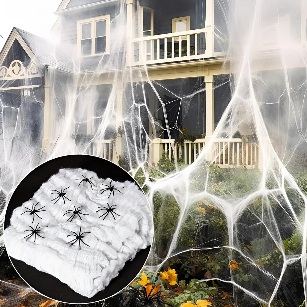 White cotton Halloween spider web decoration draped with plastic spiders for haunted house party decor.