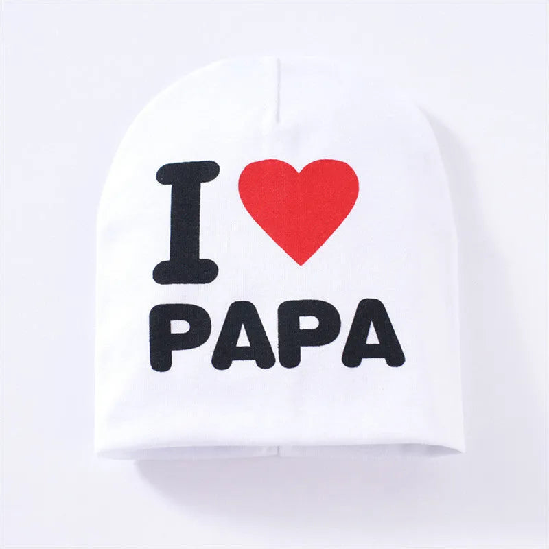 Baby hat in grey with 'Love Mama' text print, showing soft cotton-Lycra knit fabric
