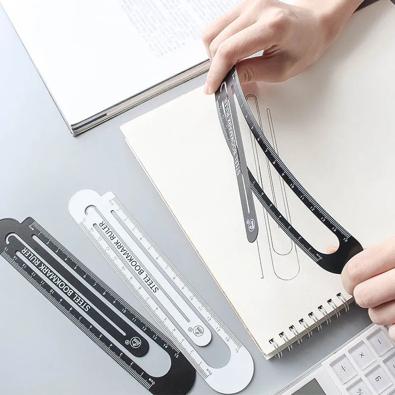 Black and white two-sided 12cm steel ruler on a wooden desk.