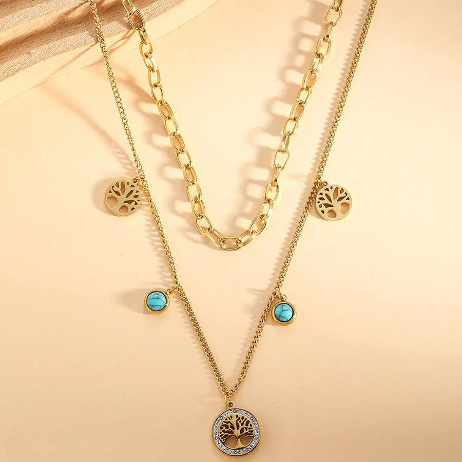 Gold titanium steel multi-layer box chain necklace with turquoise accent on model