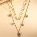 Gold titanium steel multi-layer box chain necklace with turquoise accent on model
