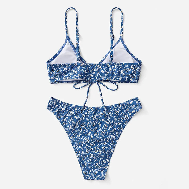 Blue women's three-piece swimsuit set with sleeveless top and shorts on a white background.