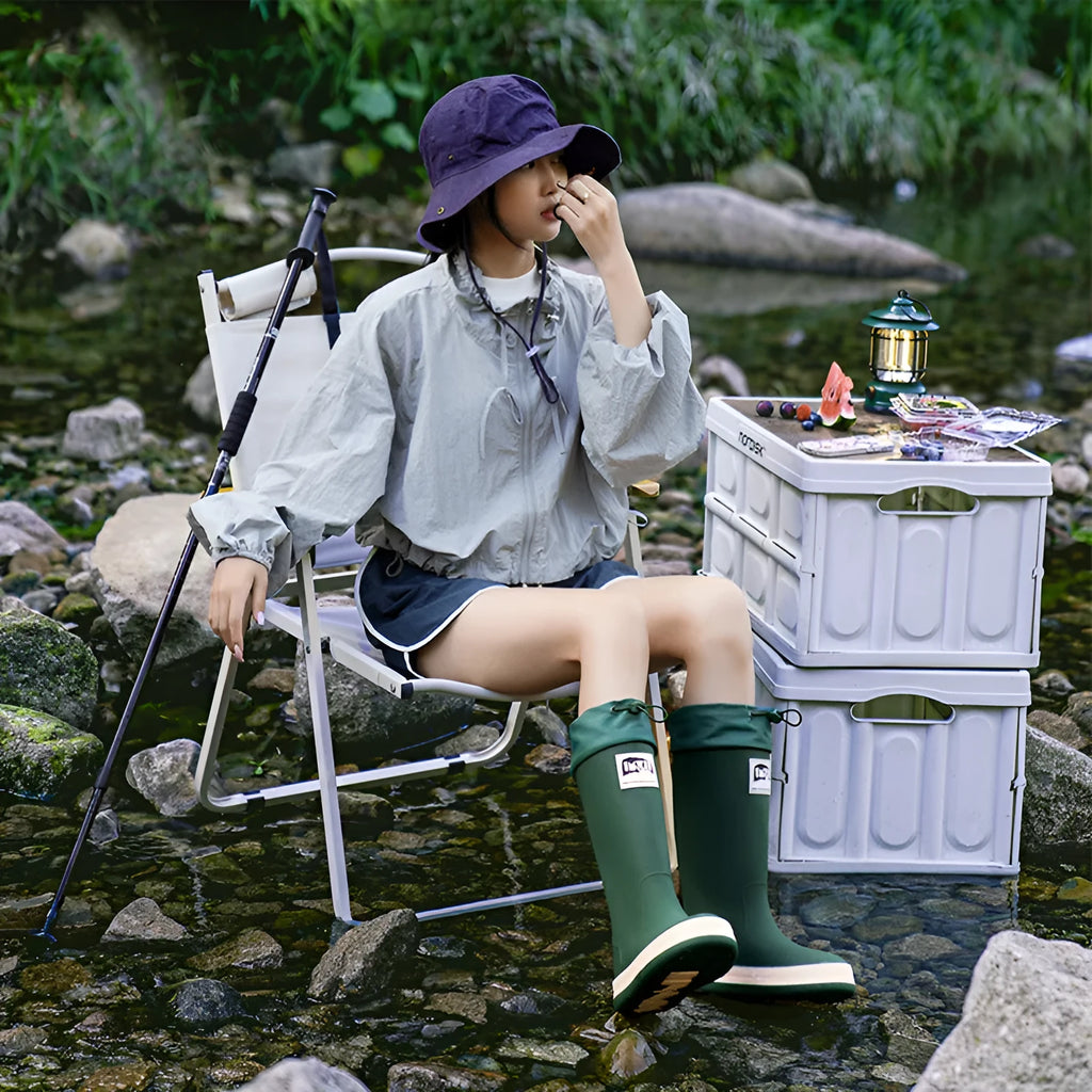 A pair of solid-colour high-tube PVC rain boots with a low heel on a plain background.
