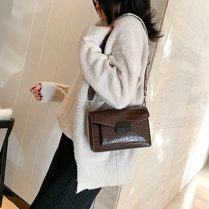 Vintage-style black PU crossbody bag with adjustable strap showing interior