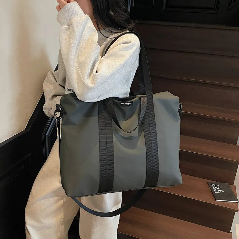 Lightweight oxford cloth tote bag in black, grey, or champagne for business travel.