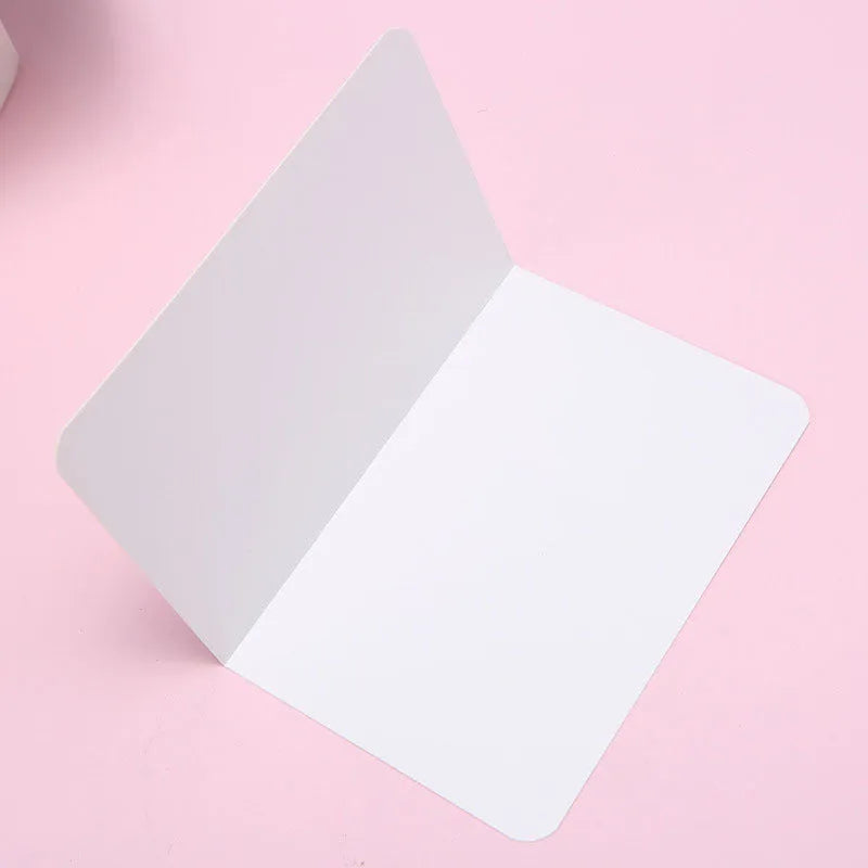 A pack of 100 blank folded kraft paper cards in 10x15cm size, shown in black, brown, and white colours.