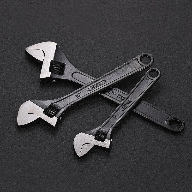 10-inch black high carbon steel adjustable open-end wrench on a workbench