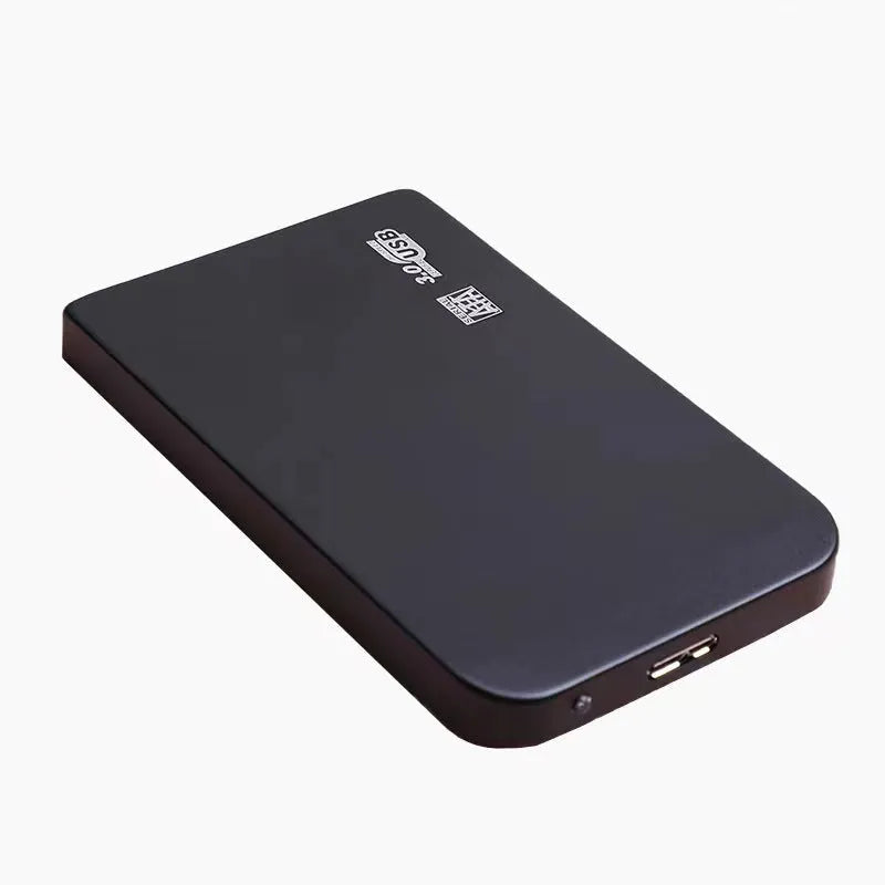 Silver USB 3.0 external solid state hard drive with data cable on a desk.