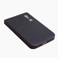 Silver USB 3.0 external solid state hard drive with data cable on a desk.