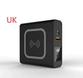Super Qi wireless power bank in black with folding plug extended and four international adapter heads.