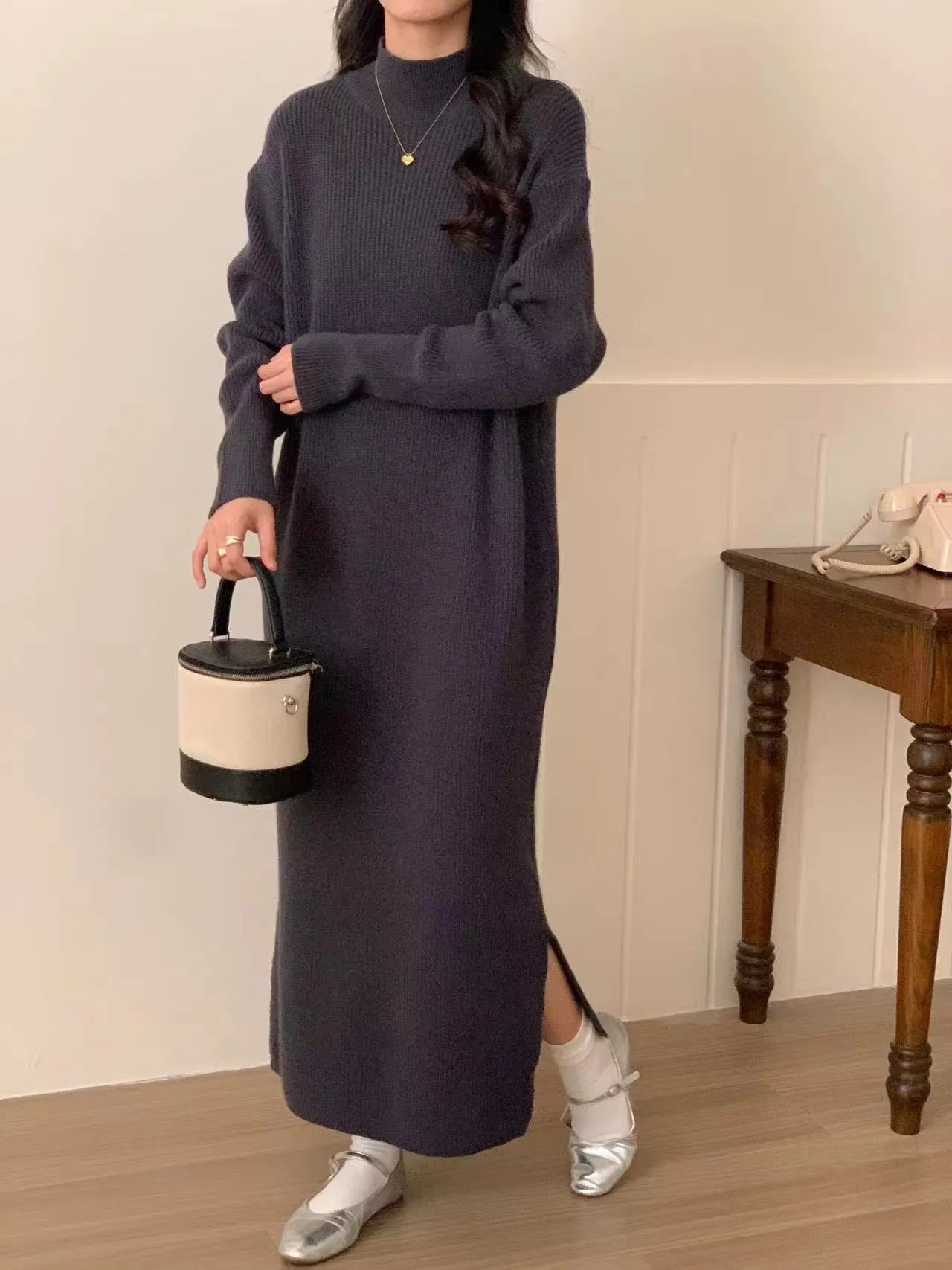 Acrylic knitted dress with half turtleneck, high waist, and midi length in solid colour