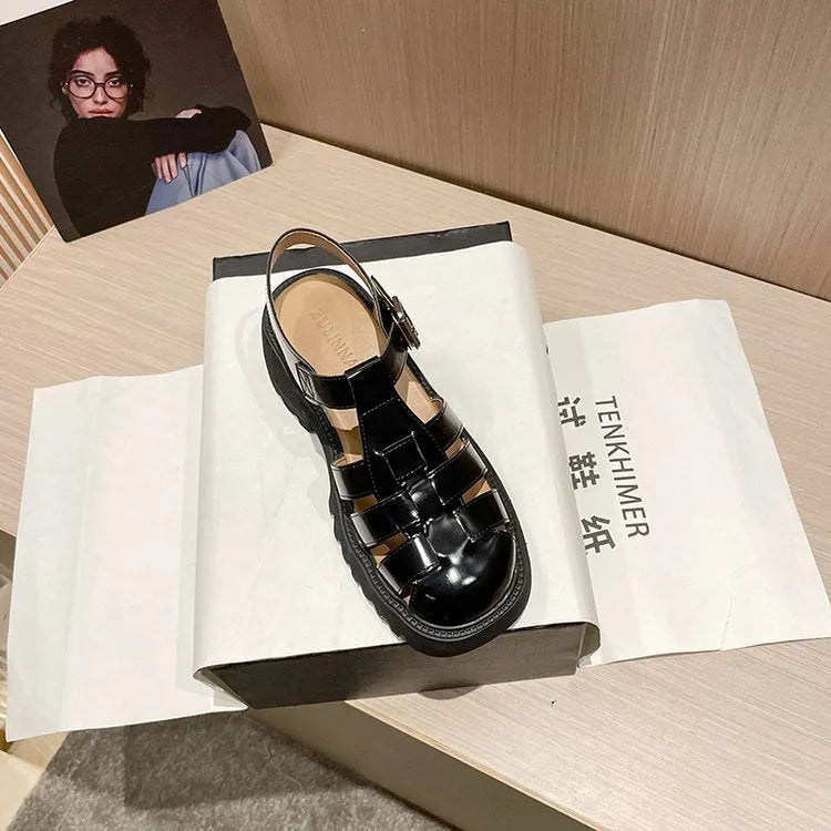 Women's black retro platform sandals with closed toe, chunky rubber sole and buckle fastening
