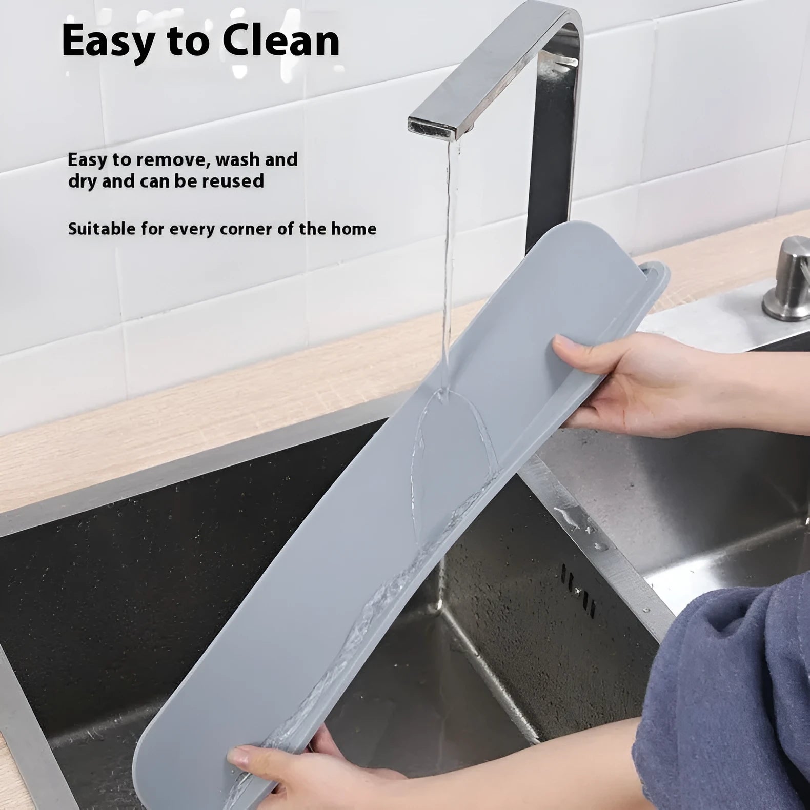 Grey blue silicone sink water blocking plate measuring 52mm by 85mm on a kitchen counter.