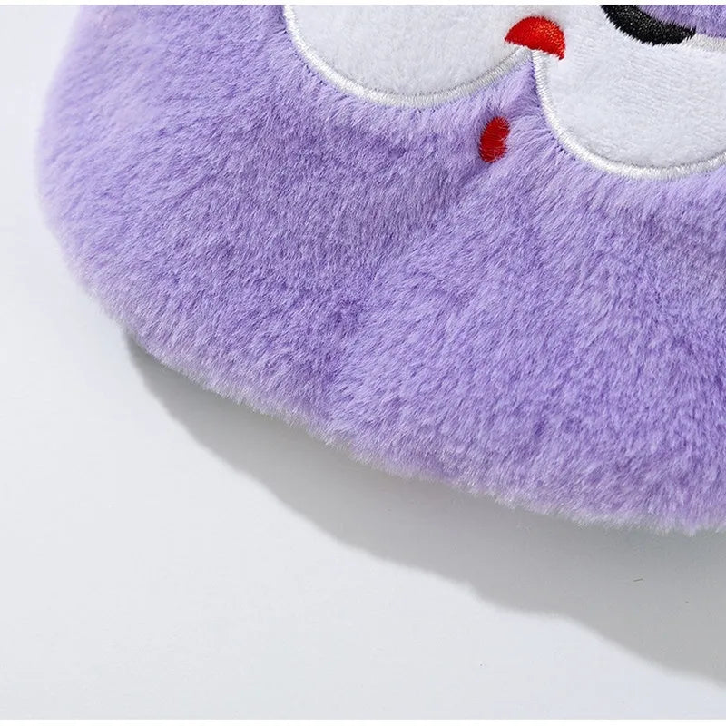 Small dog wearing a pink cartoon bear hoodie with matching detachable scarf, standing indoors