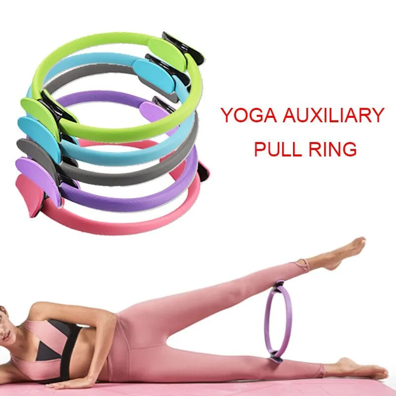 Pink pilates ring with ergonomic design on white background for yoga and home workout resistance training