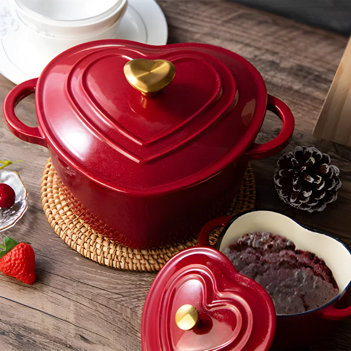 Heart-shaped cast iron enamel stew pot in Milk White with lid on a stovetop
