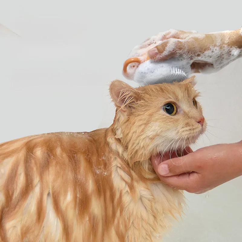 Orange TPR dog bath brush with shampoo dispenser, massage bristles and comb teeth.