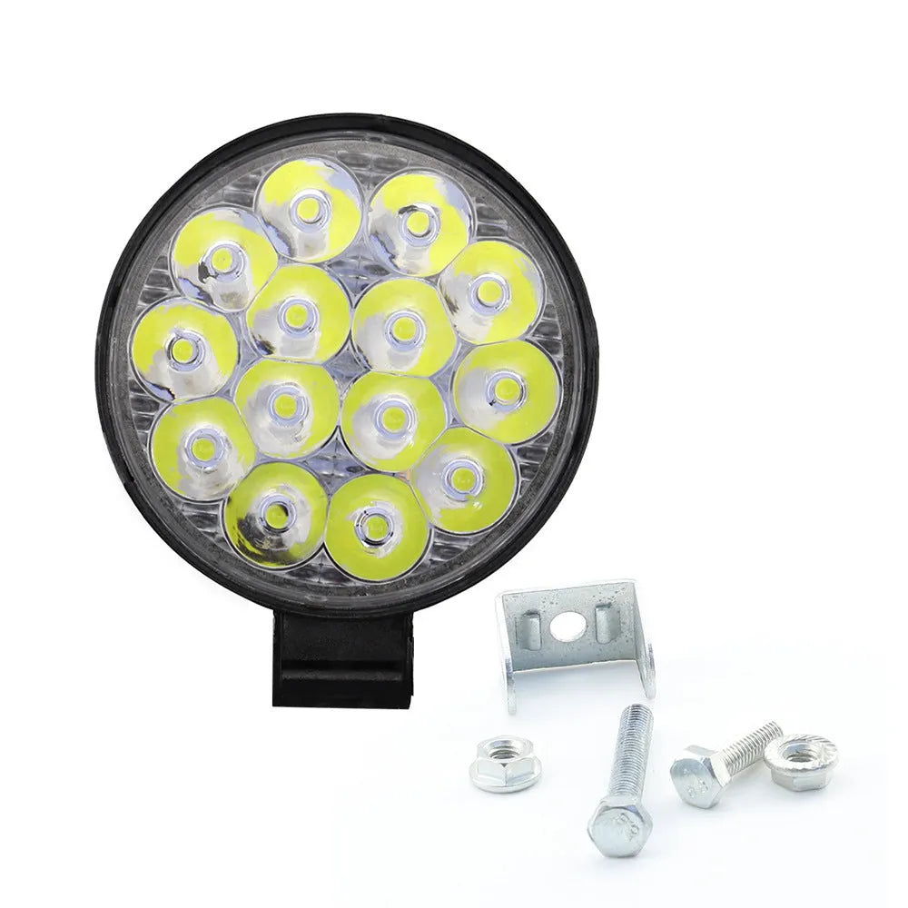 Compact round aluminium LED work light with white light, suitable for vehicle mounting.