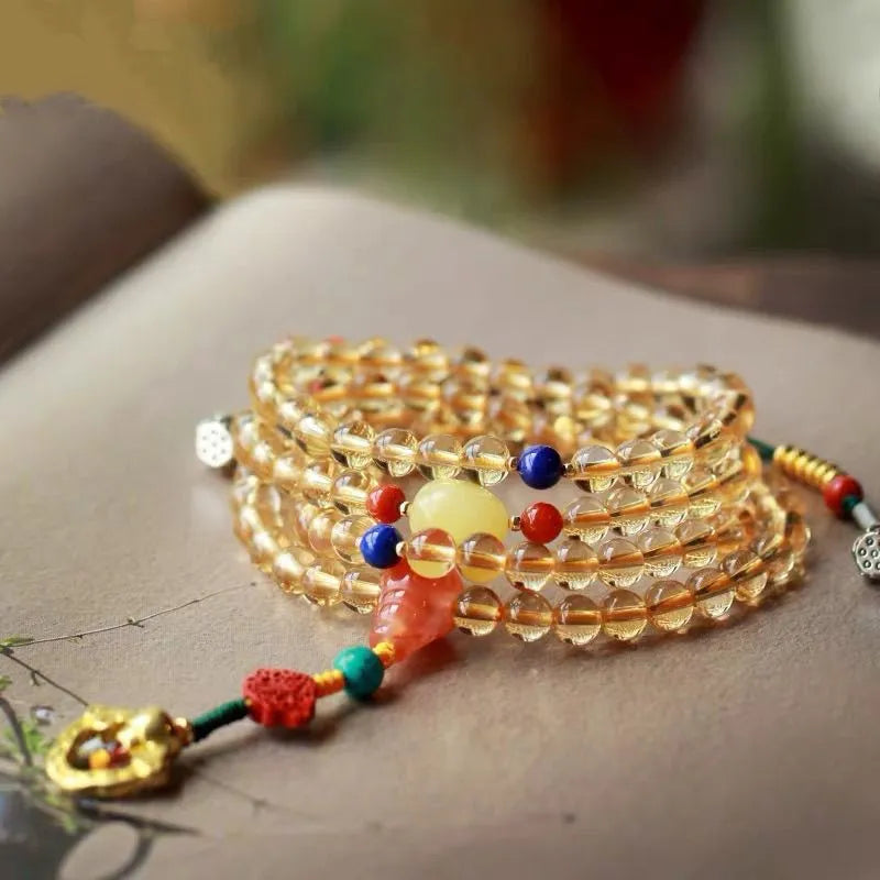 Yellow natural Brazilian citrine bracelet with 1mm beads and filament fastening on a wrist.