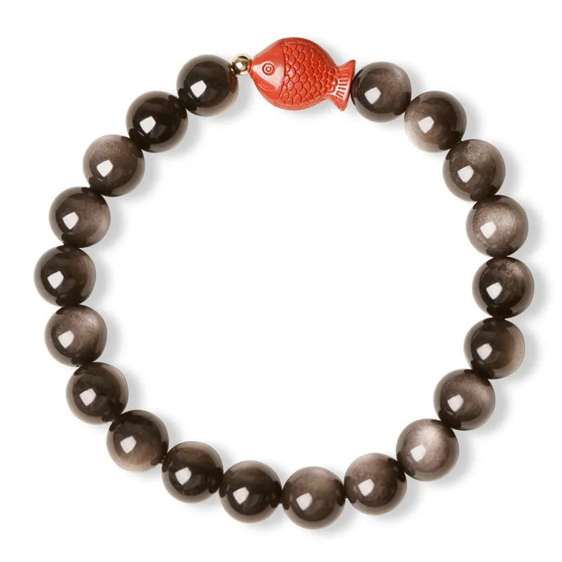 Natural black obsidian round bead bracelet with red cinnabar fungus decorative elements.