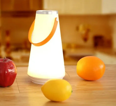 White rechargeable LED lantern night light on a wooden bedside table.