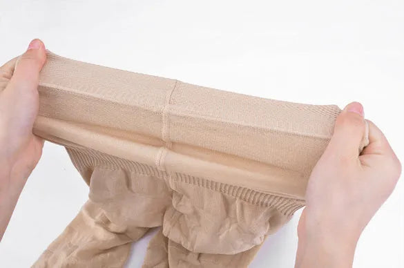 Black high-waisted seamless shapewear shorts for women on a hanger.
