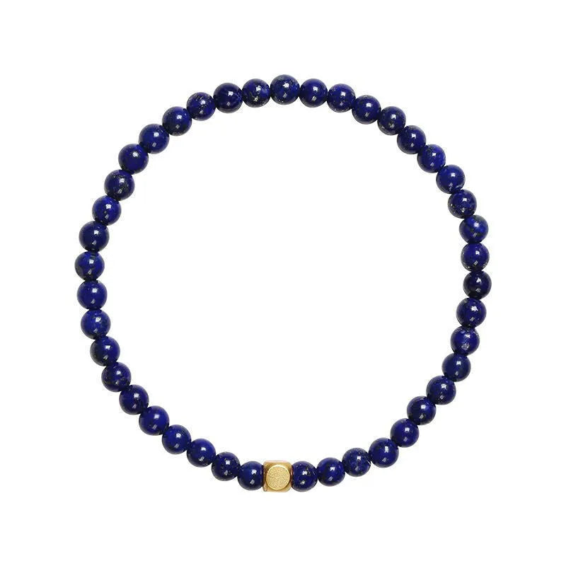 Close-up of a women's bracelet with a large 16mm geometric green gold stone crystal bead.