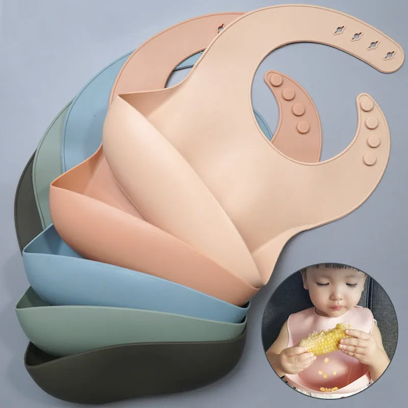 Soft waterproof silicone baby bib with food catcher in pink, with adjustable neck closure