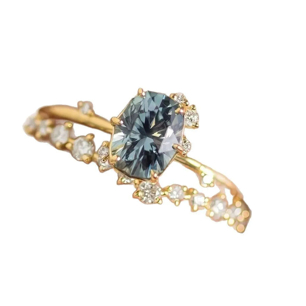 Gold plated women's flower-shaped ring with a green zircon stone, shown in a pair.