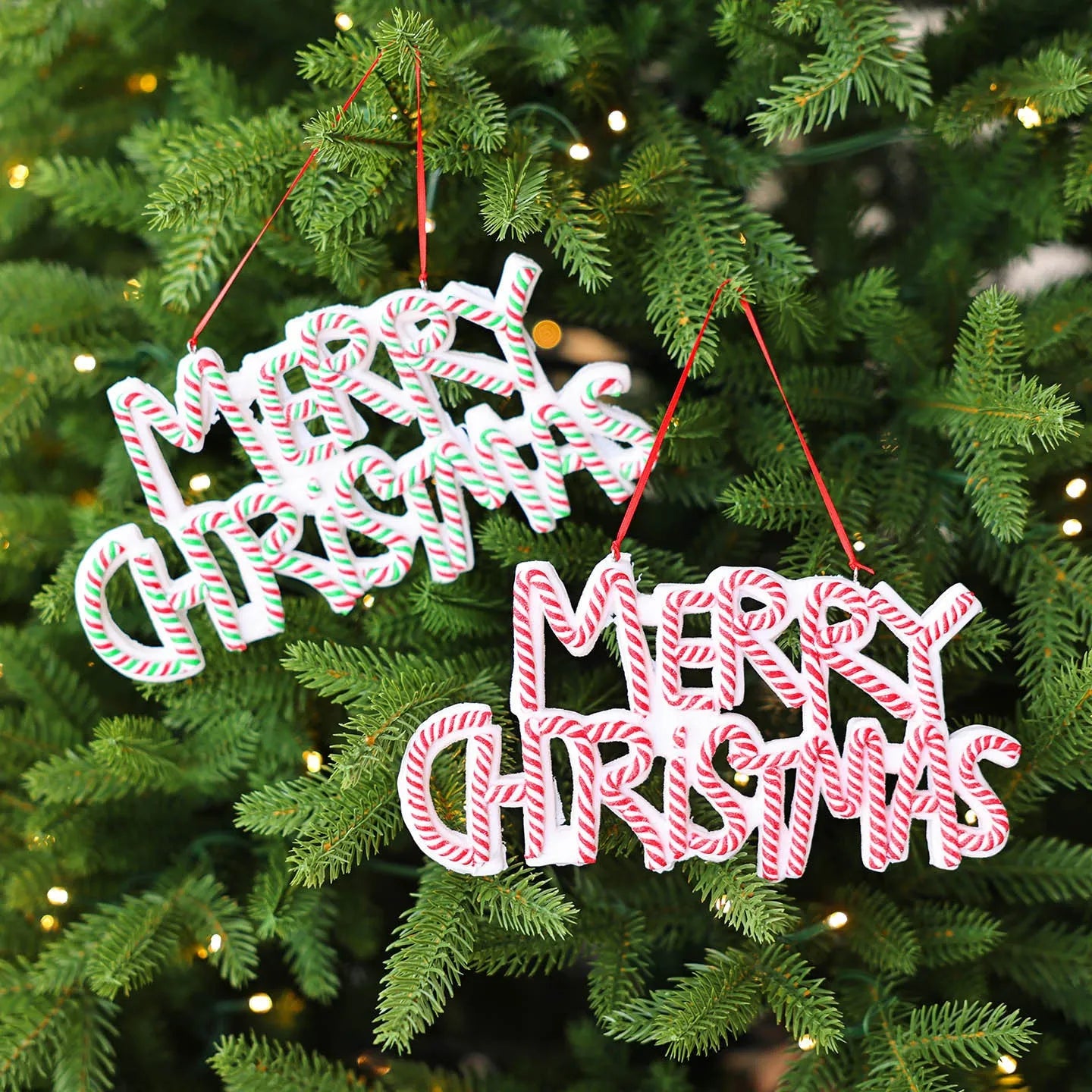 Merry Christmas letter plate polymer clay ornament in red and white hanging on Christmas tree branch