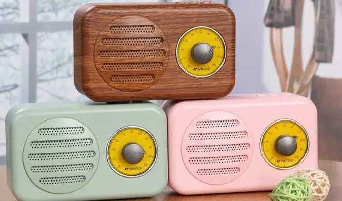 Compact portable Bluetooth speaker in wood colour finish with FM radio and USB cable.