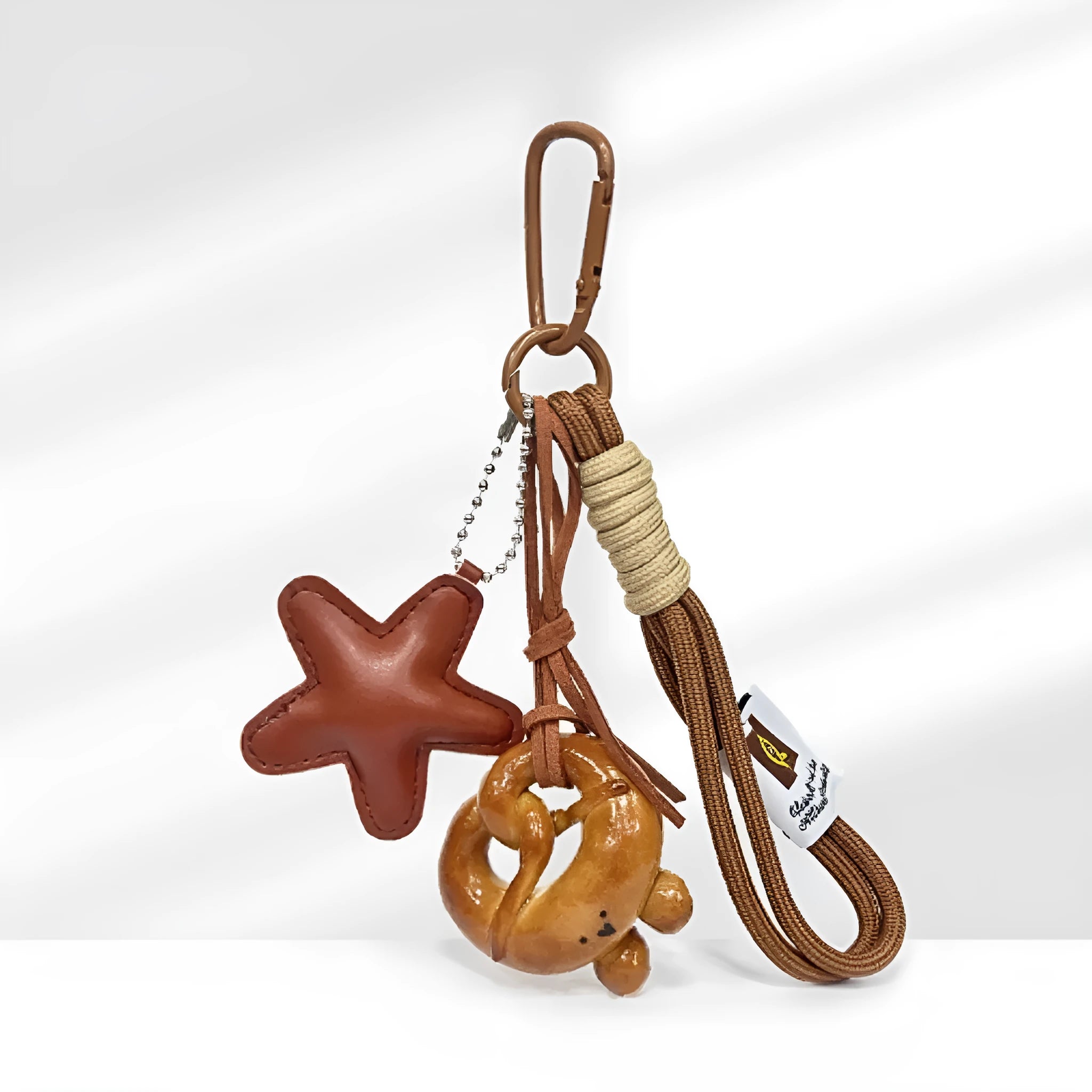 Handmade soda bread style handbag pendant with cartoon baked goods and brown star motifs