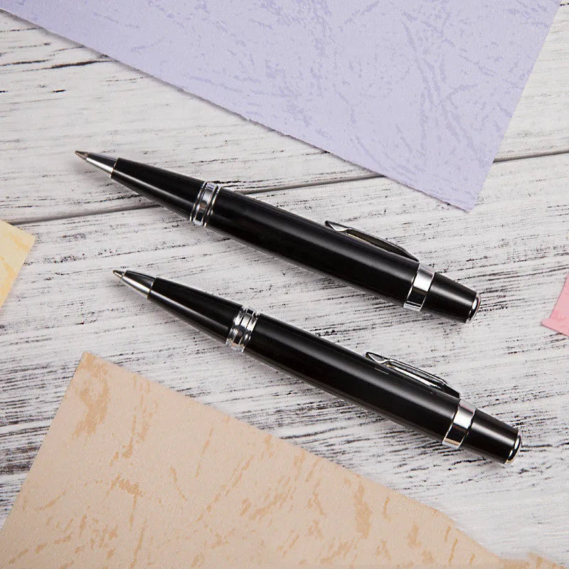 Short black metal ballpoint pen with rotating mechanism shown retracted and extended.