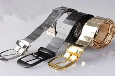 Shiny metallic belt shown in black, gold, and silver for parties and evening wear
