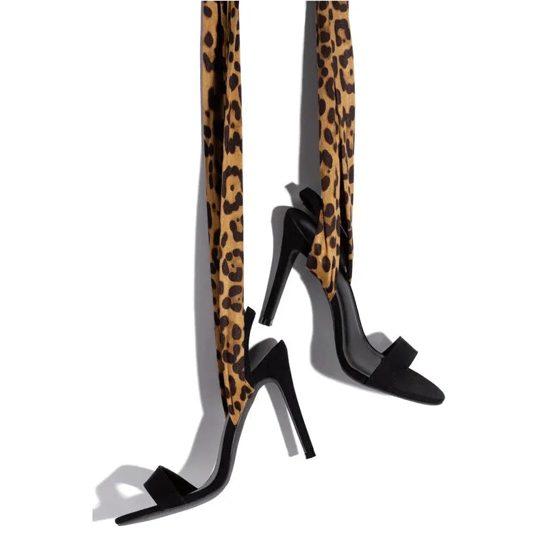 Light brown leopard print women's high heels with cross straps and a fine super high heel.