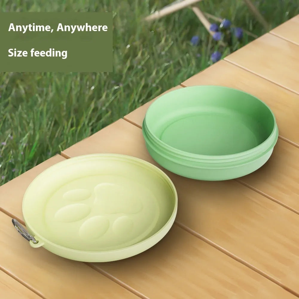 Portable dog feeding bowl with a removable silicone base in pink and green colour options.