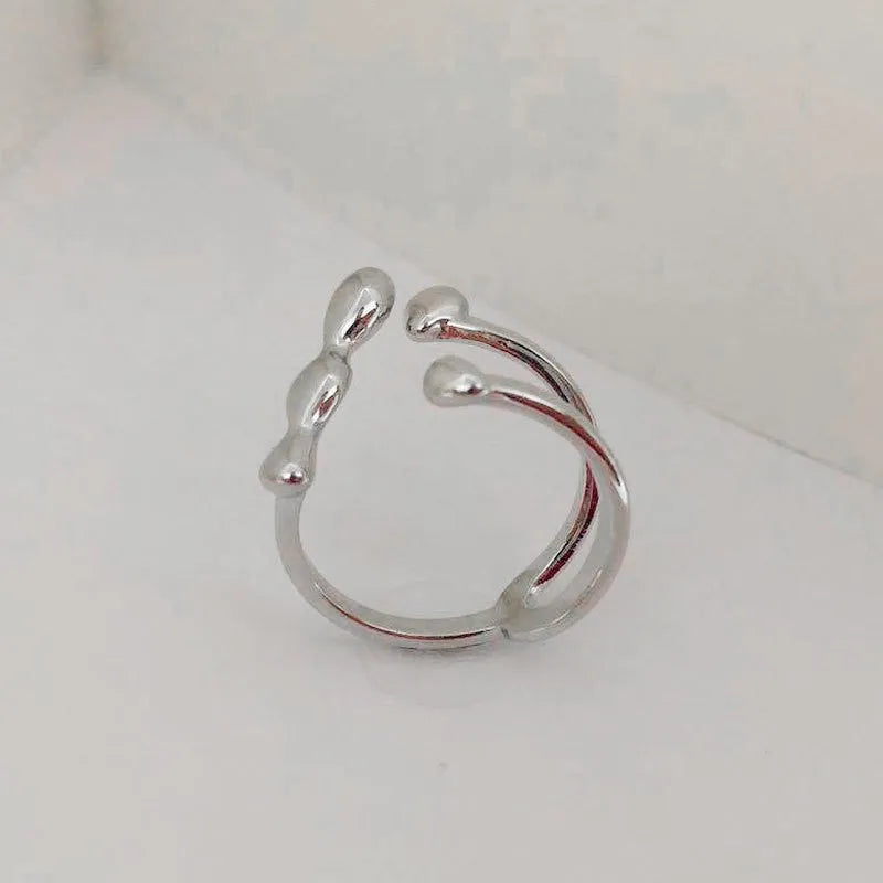 Adjustable brass ring with sphere design in gold or silver plating.