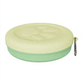 Portable dog feeding bowl with a removable silicone base in pink and green colour options.